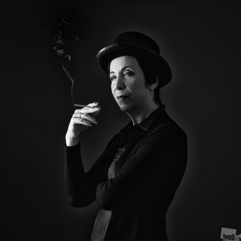 Портрет курящей женщины в шляпе.